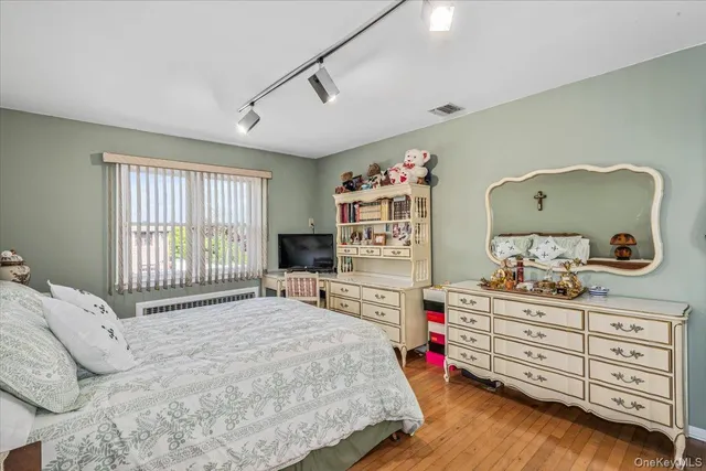 a bedroom with a bed and a dresser in it