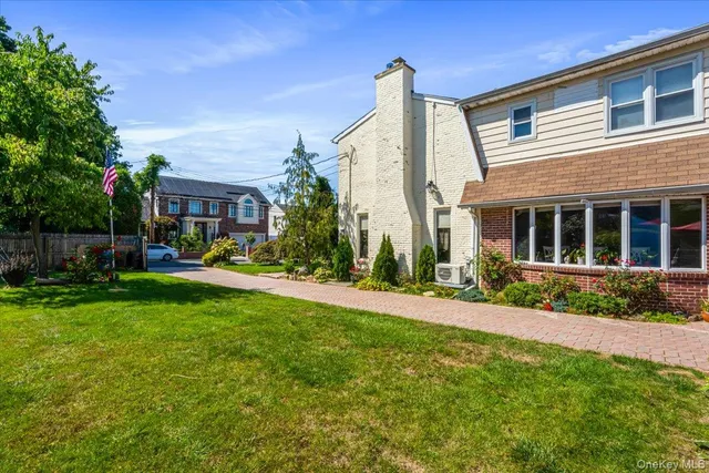 a front view of a house with a yard and porch