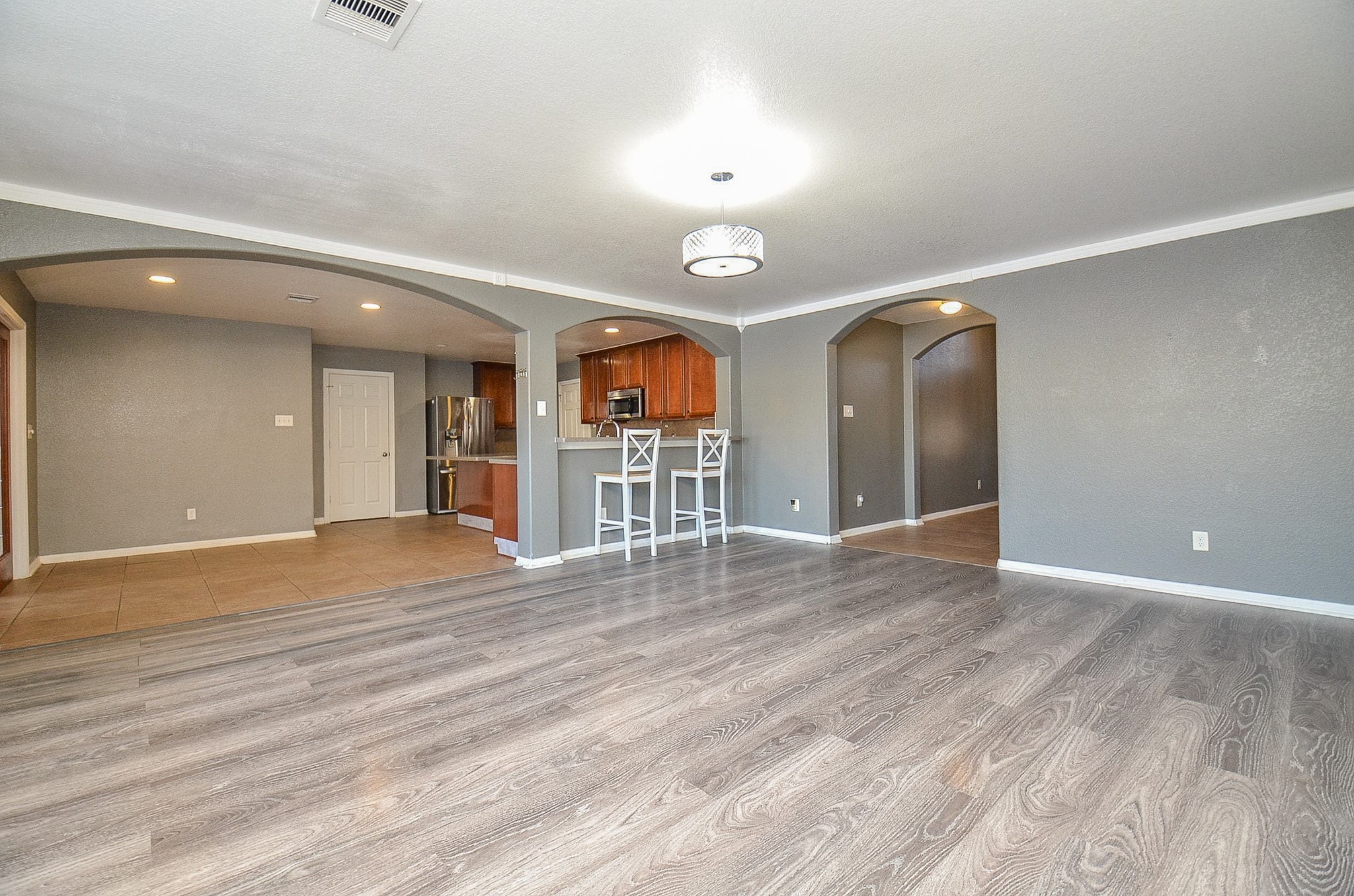 5411 Rio Drive Baytown, TX 77521 - Photo 2 of 30 Open-concept living area, dining space, and kitchen in one cohesive layout, creating a welcoming and functional heart of the home.