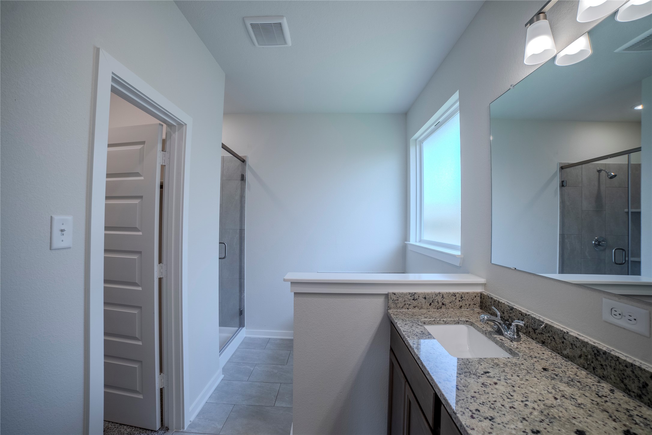 1402 Lk Rdg Drive Brenham, TX 77833 - Photo 31 of 35 a bathroom with a granite countertop sink and a mirror