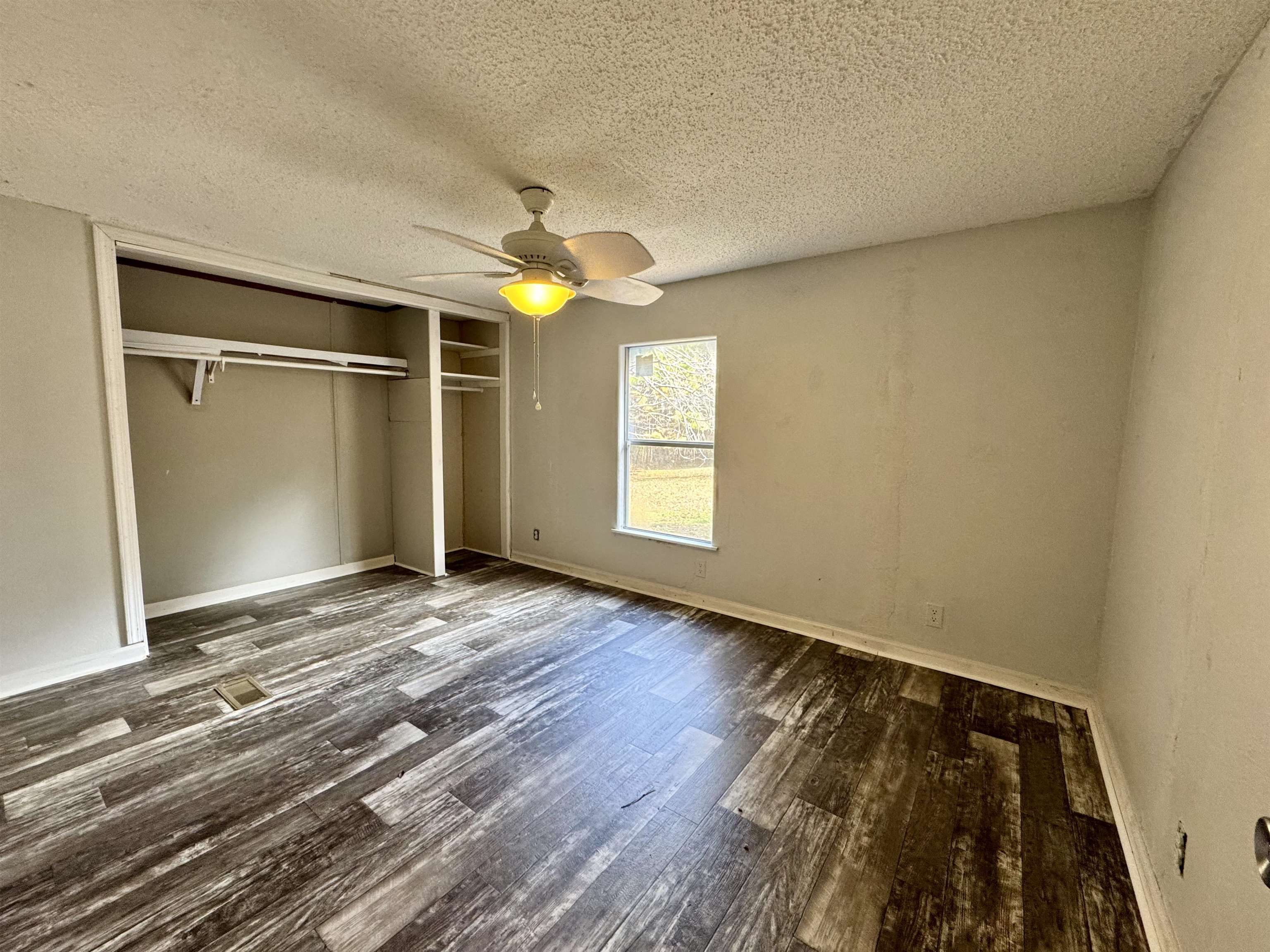 855 Beason Drive Morris Chapel, TN 38361 - Photo 11 of 21 a view of an empty room with window and wooden floor