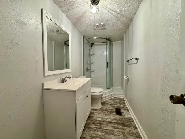 a bathroom with a sink and mirror with toilet