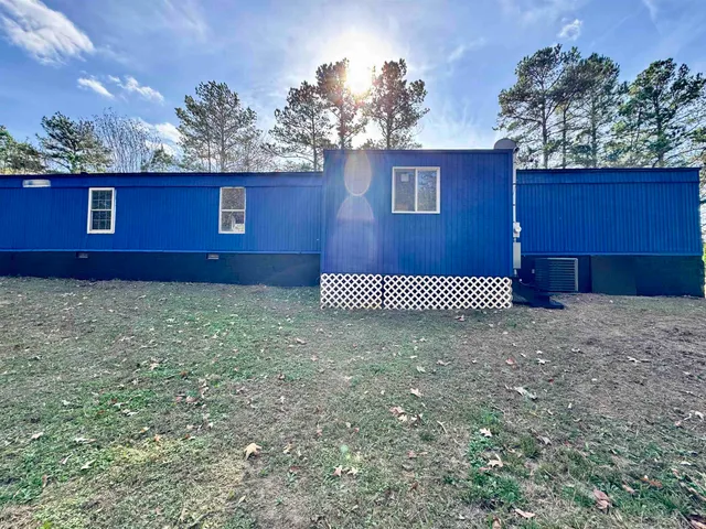 a view of a yard with red house