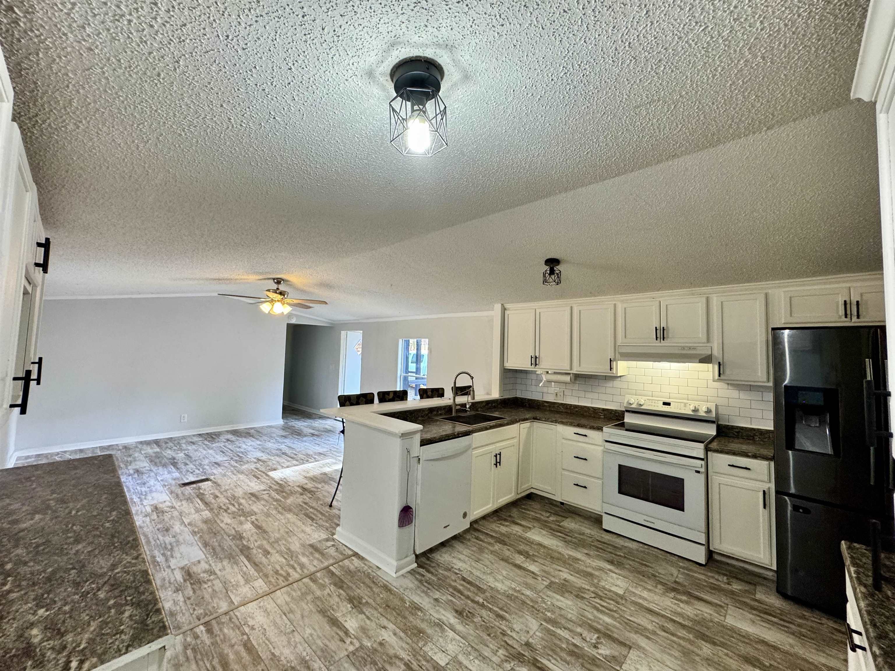 855 Beason Drive Morris Chapel, TN 38361 - Photo 5 of 21 a kitchen with granite countertop a stove top oven sink and cabinets