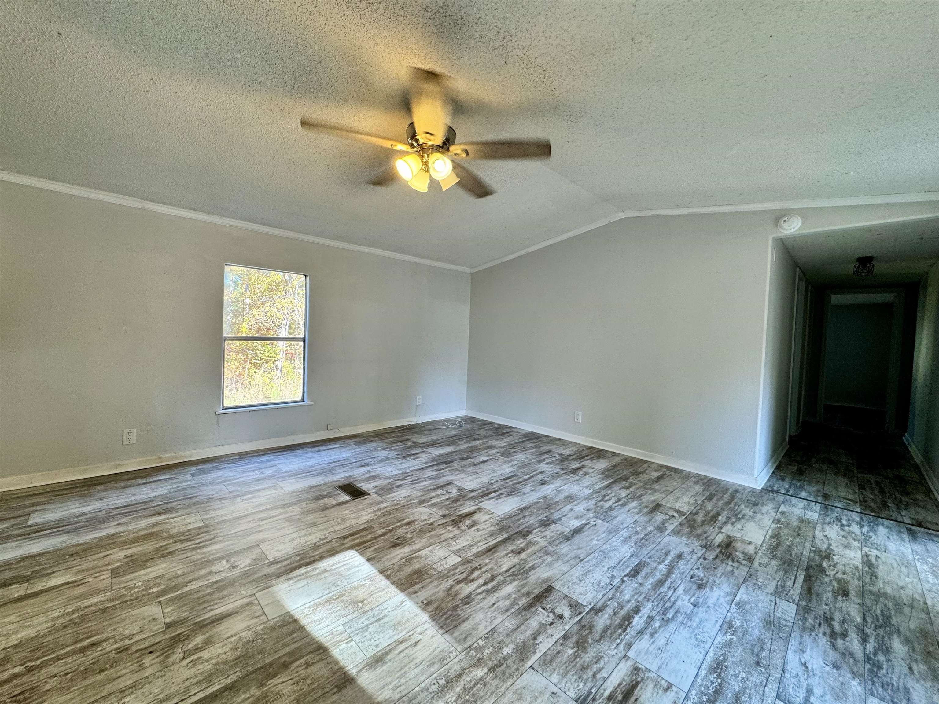 855 Beason Drive Morris Chapel, TN 38361 - Photo 8 of 21 wooden floor in an empty room with a window