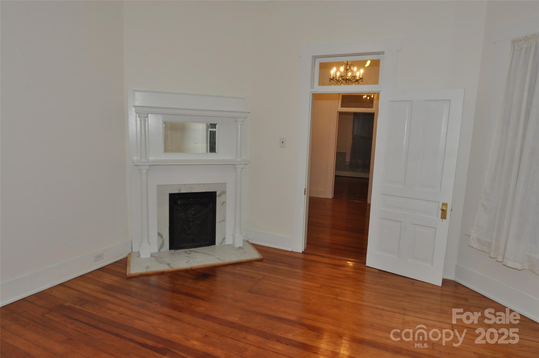 152 Saluda Street Chester, SC 29706 - Photo 11 of 24 a view of an empty room with wooden floor and a window
