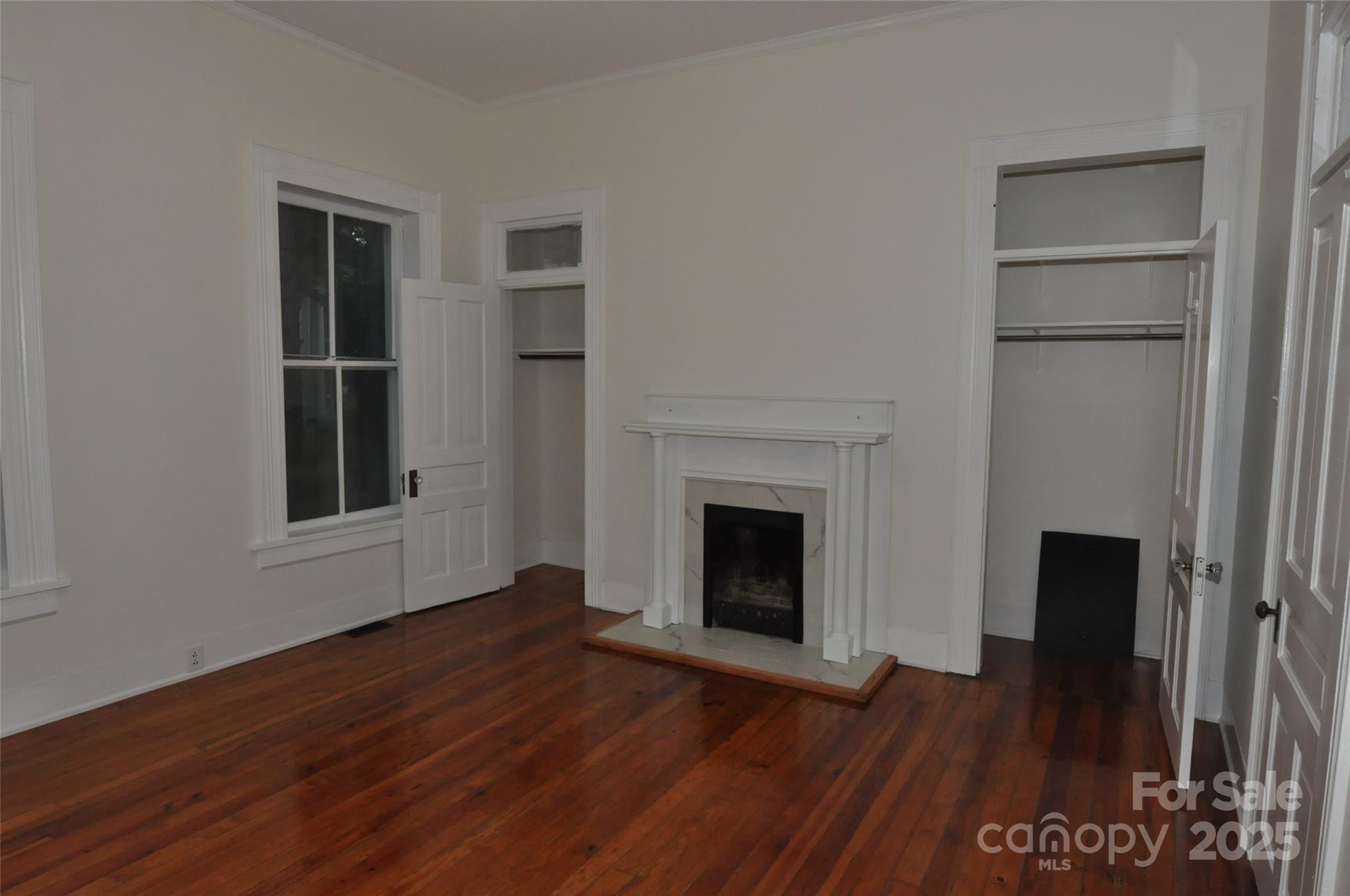 152 Saluda Street Chester, SC 29706 - Photo 13 of 24 a view of empty room with a fireplace and wooden floor