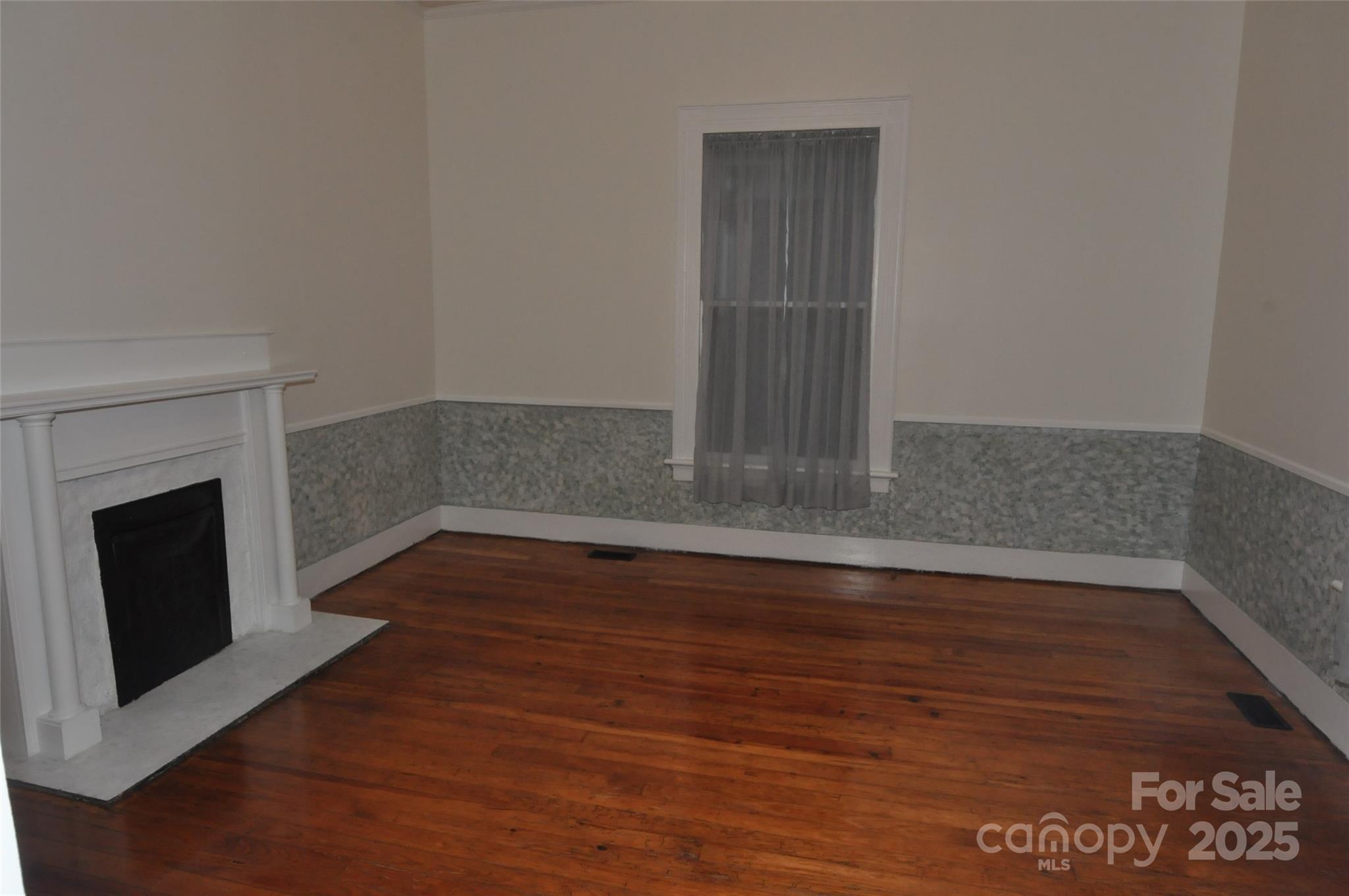 152 Saluda Street Chester, SC 29706 - Photo 7 of 24 a view of a room with wooden floor and fireplace