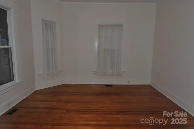 a view of wooden floor and cabinets in a room