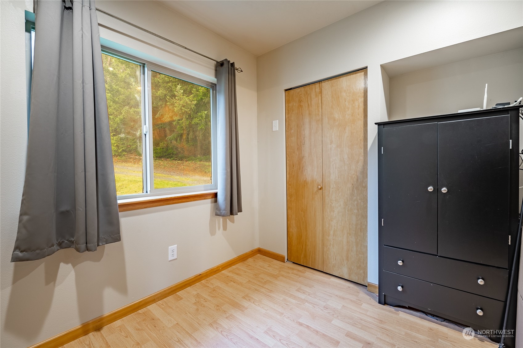 2940 Cedar Avenue Lummi Island, WA 98262 - Photo 22 of 36 a view of an empty room with wooden floor and a window