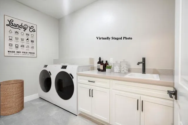 a utility room with sink dryer and washer