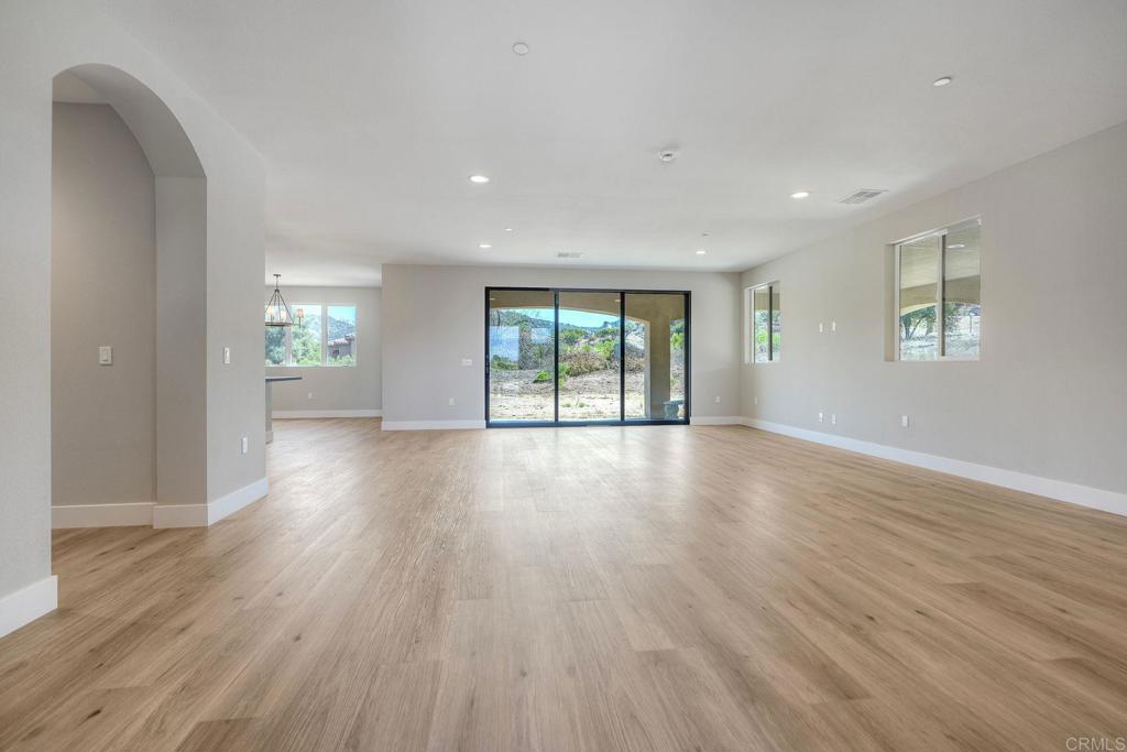 12073 Via Trevi, Unit LOT 2 Lakeside, CA 92040 - Photo 17 of 33 an empty room with wooden floor and windows