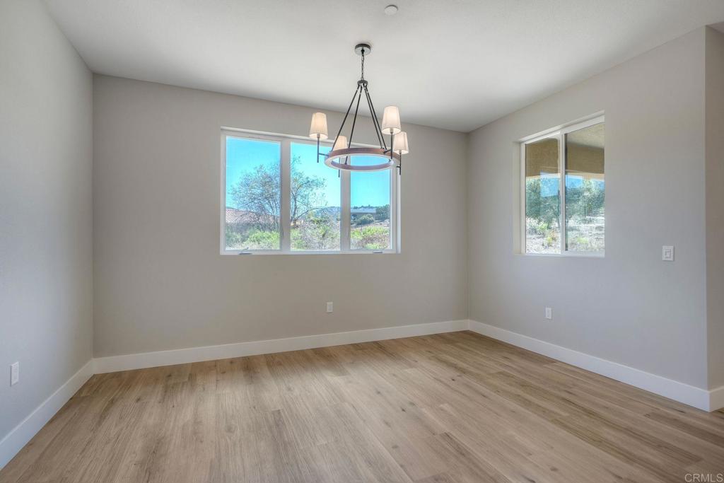 12073 Via Trevi, Unit LOT 2 Lakeside, CA 92040 - Photo 22 of 33 an empty room with wooden floor and windows