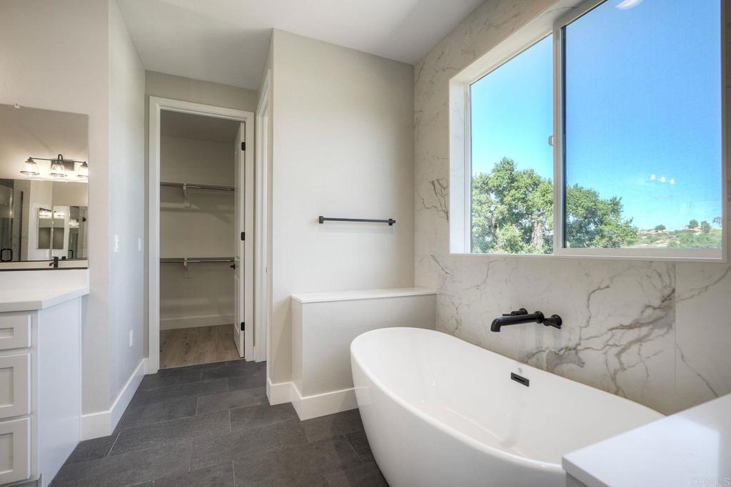 12073 Via Trevi, Unit LOT 2 Lakeside, CA 92040 - Photo 23 of 33 a white bath tub sitting in a bathroom next to a window
