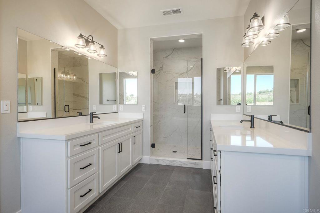12073 Via Trevi, Unit LOT 2 Lakeside, CA 92040 - Photo 24 of 33 a spacious bathroom with a granite countertop sink a large mirror a shower and a bathtub