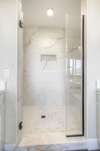 a spacious bathroom with double vanity a large mirror a vanity a bathtub and next to a window