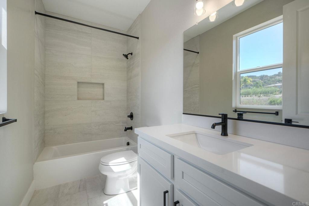 12073 Via Trevi, Unit LOT 2 Lakeside, CA 92040 - Photo 31 of 33 a bathroom with a sink a toilet and shower