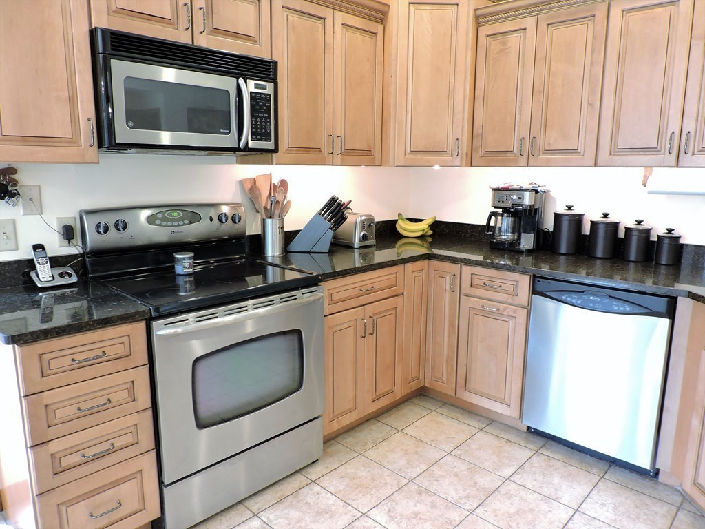 95 Chipman Road Middlefield, MA 01011 - Photo 8 of 30 a kitchen with granite countertop white cabinets and stainless steel appliances
