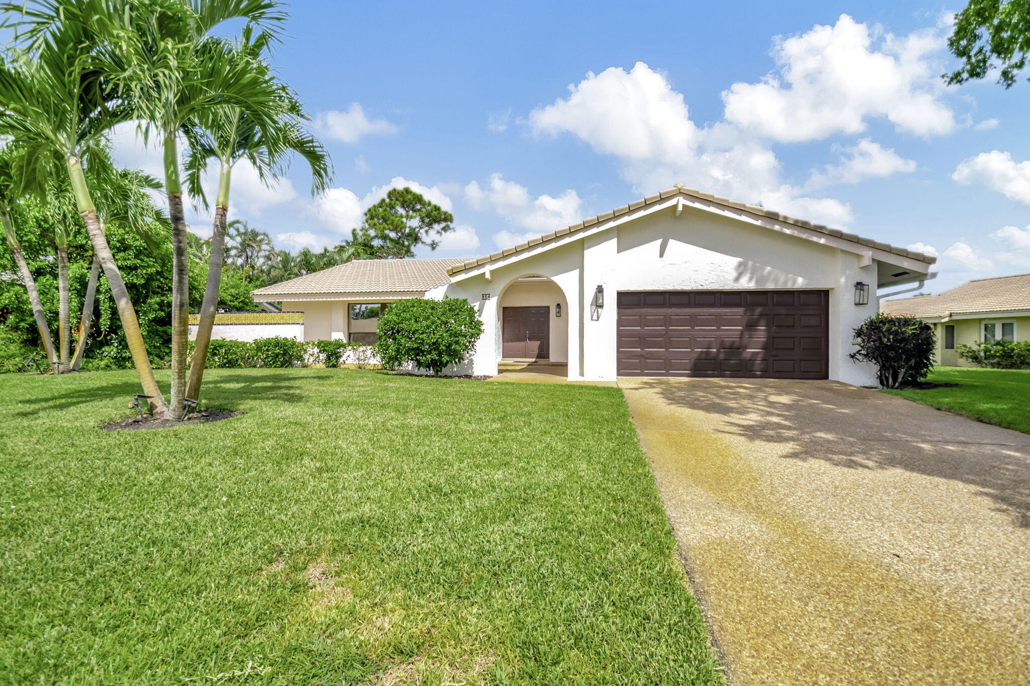 804 Foxpointe Circle Delray Beach, FL 33445 - Photo 1 of 43 a front view of a house with a yard and garage