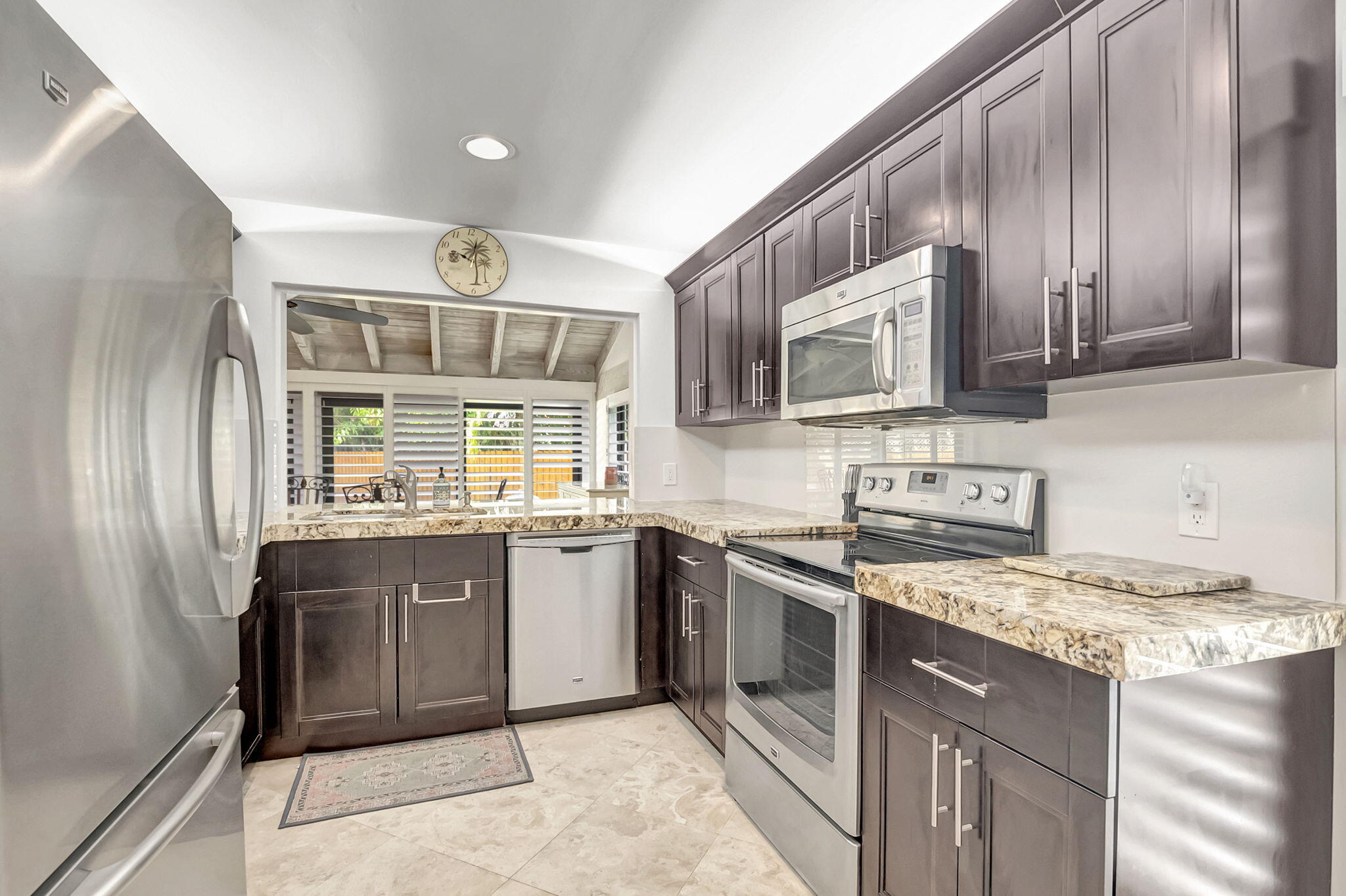 804 Foxpointe Circle Delray Beach, FL 33445 - Photo 17 of 43 a kitchen with stainless steel appliances granite countertop a stove sink microwave and refrigerator