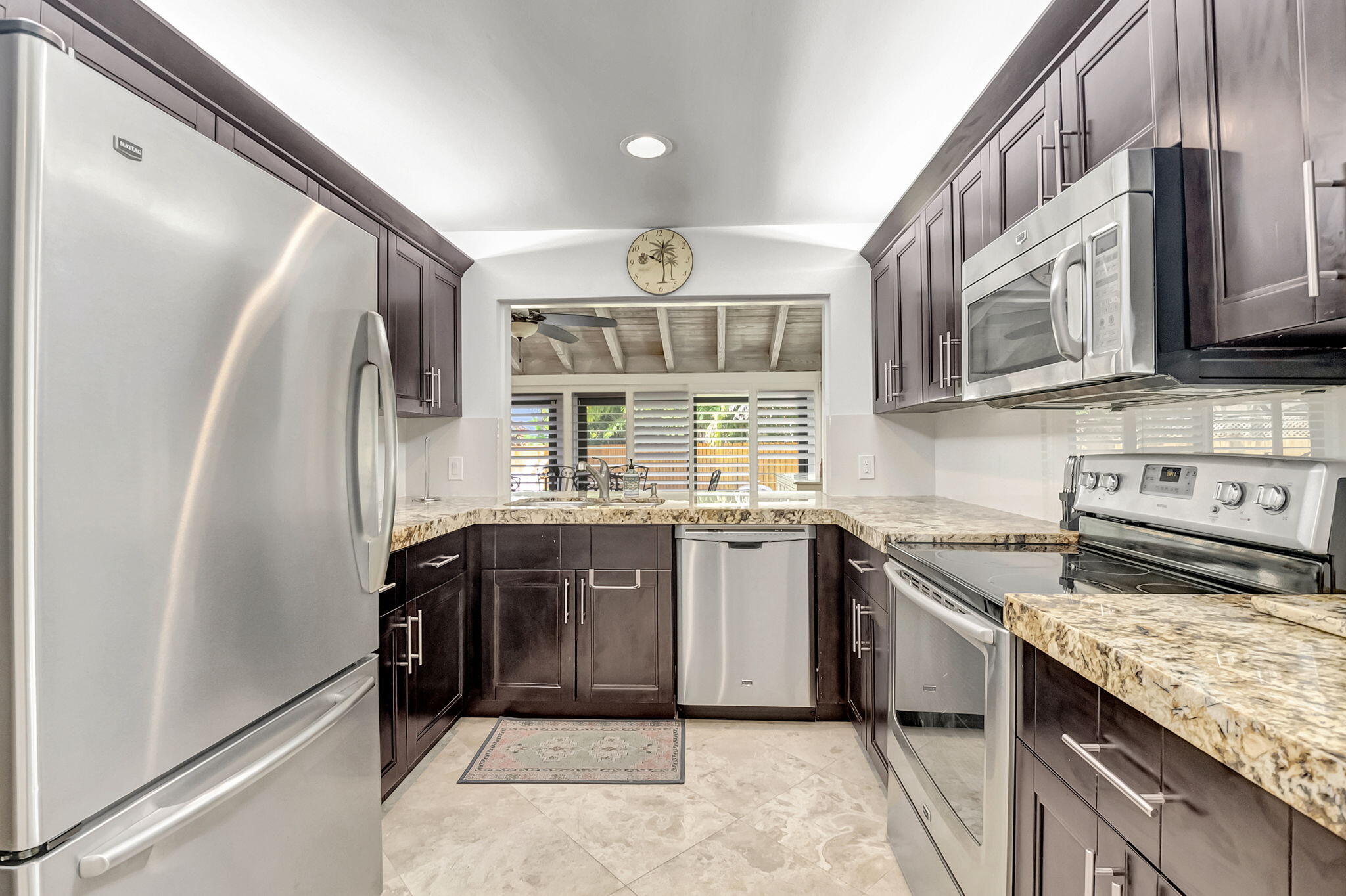 804 Foxpointe Circle Delray Beach, FL 33445 - Photo 18 of 43 a kitchen with stainless steel appliances granite countertop a sink stove and refrigerator