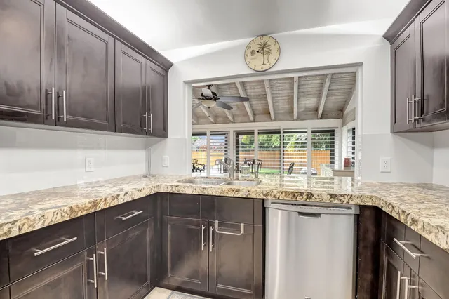 a kitchen with granite countertop a sink and a window