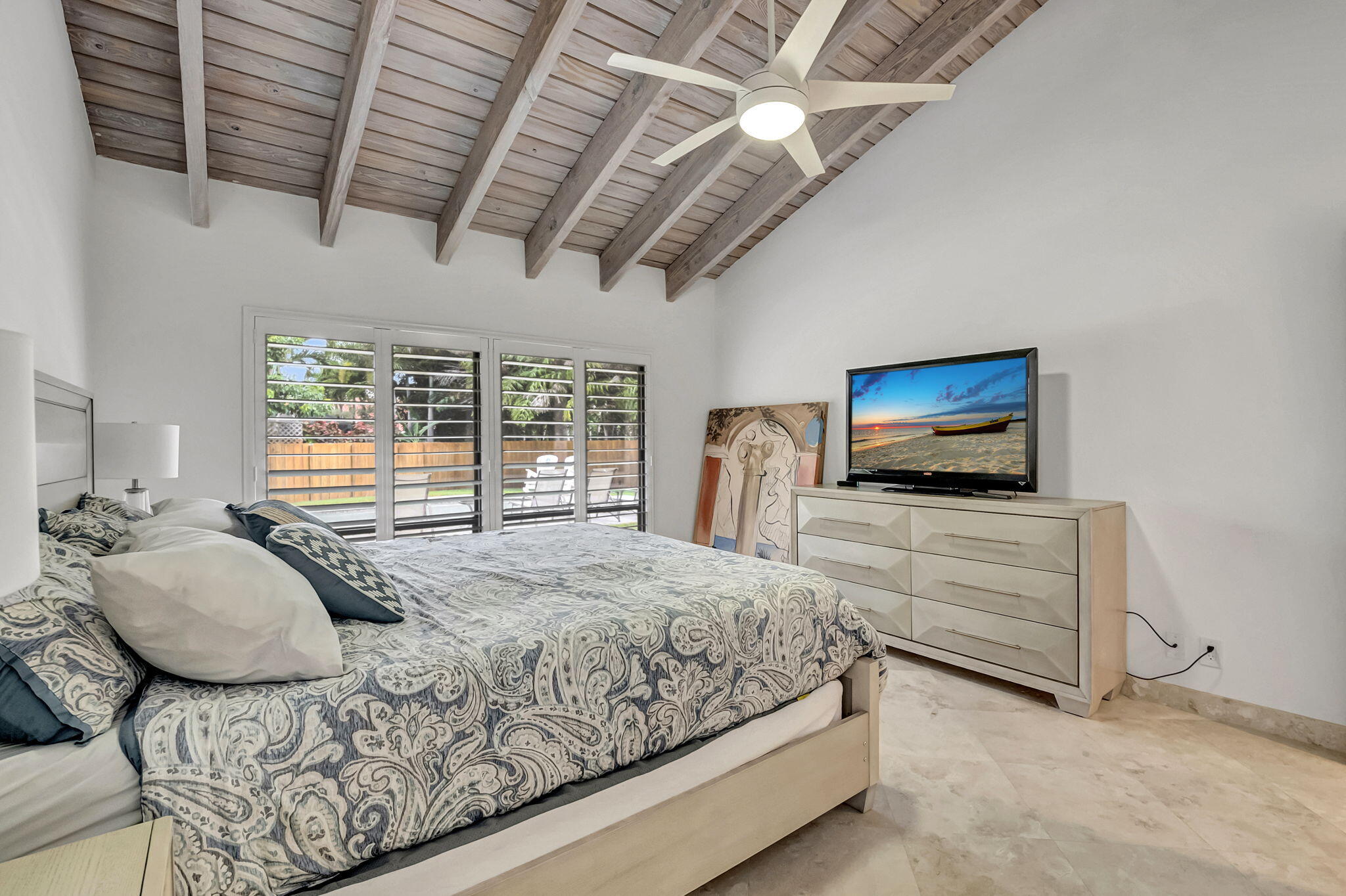 804 Foxpointe Circle Delray Beach, FL 33445 - Photo 30 of 43 a bedroom with a bed and a flat screen tv