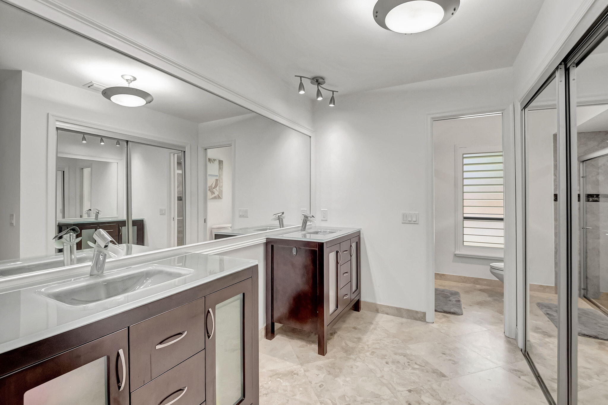 804 Foxpointe Circle Delray Beach, FL 33445 - Photo 31 of 43 a spacious bathroom with a sink double vanity and a mirror
