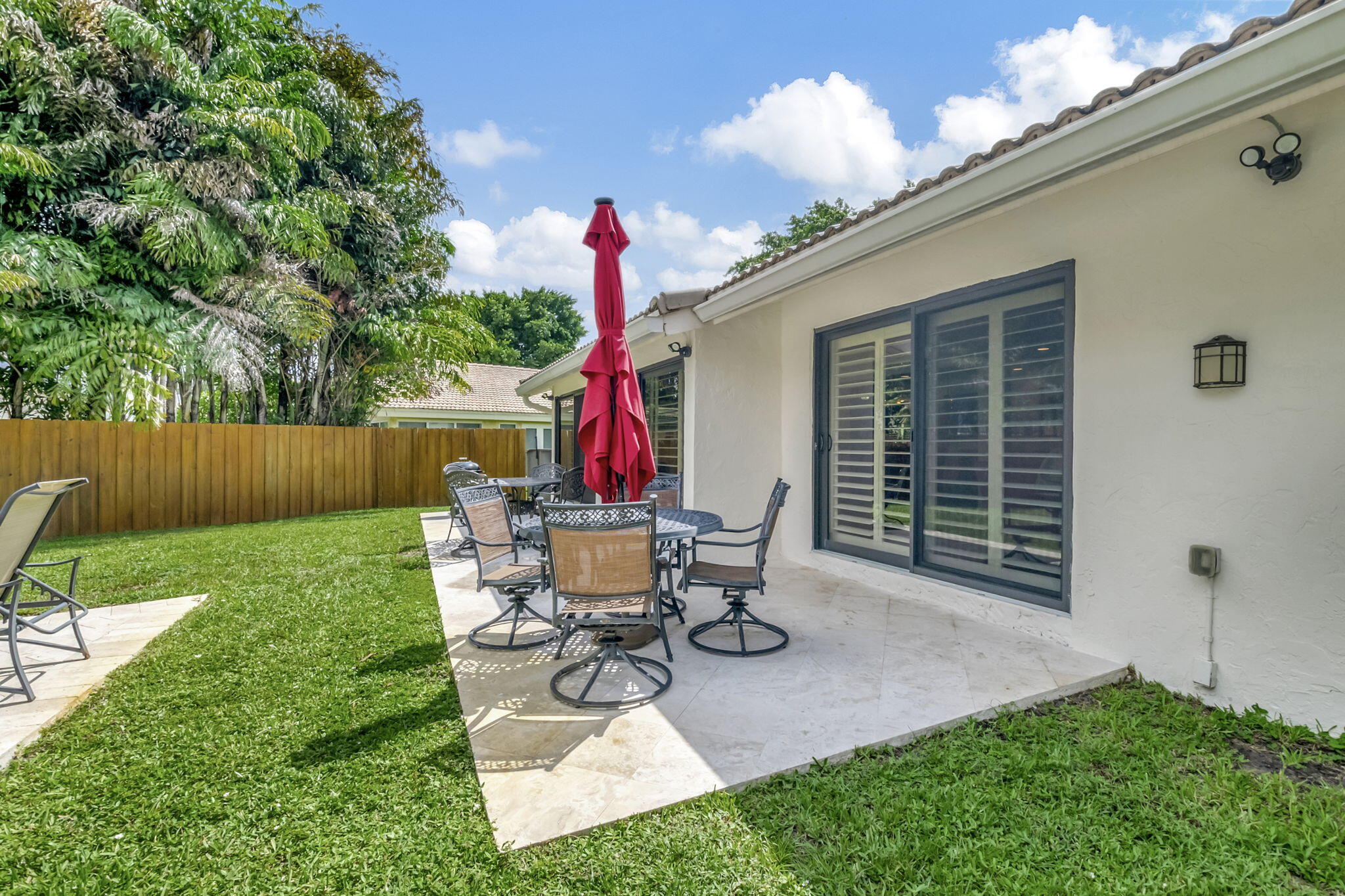 804 Foxpointe Circle Delray Beach, FL 33445 - Photo 35 of 43 a view of a chair and table in backyard of the house