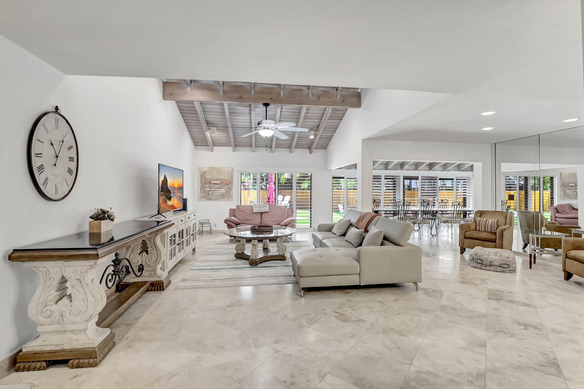 804 Foxpointe Circle Delray Beach, FL 33445 - Photo 7 of 43 a living room with furniture a clock and a large window