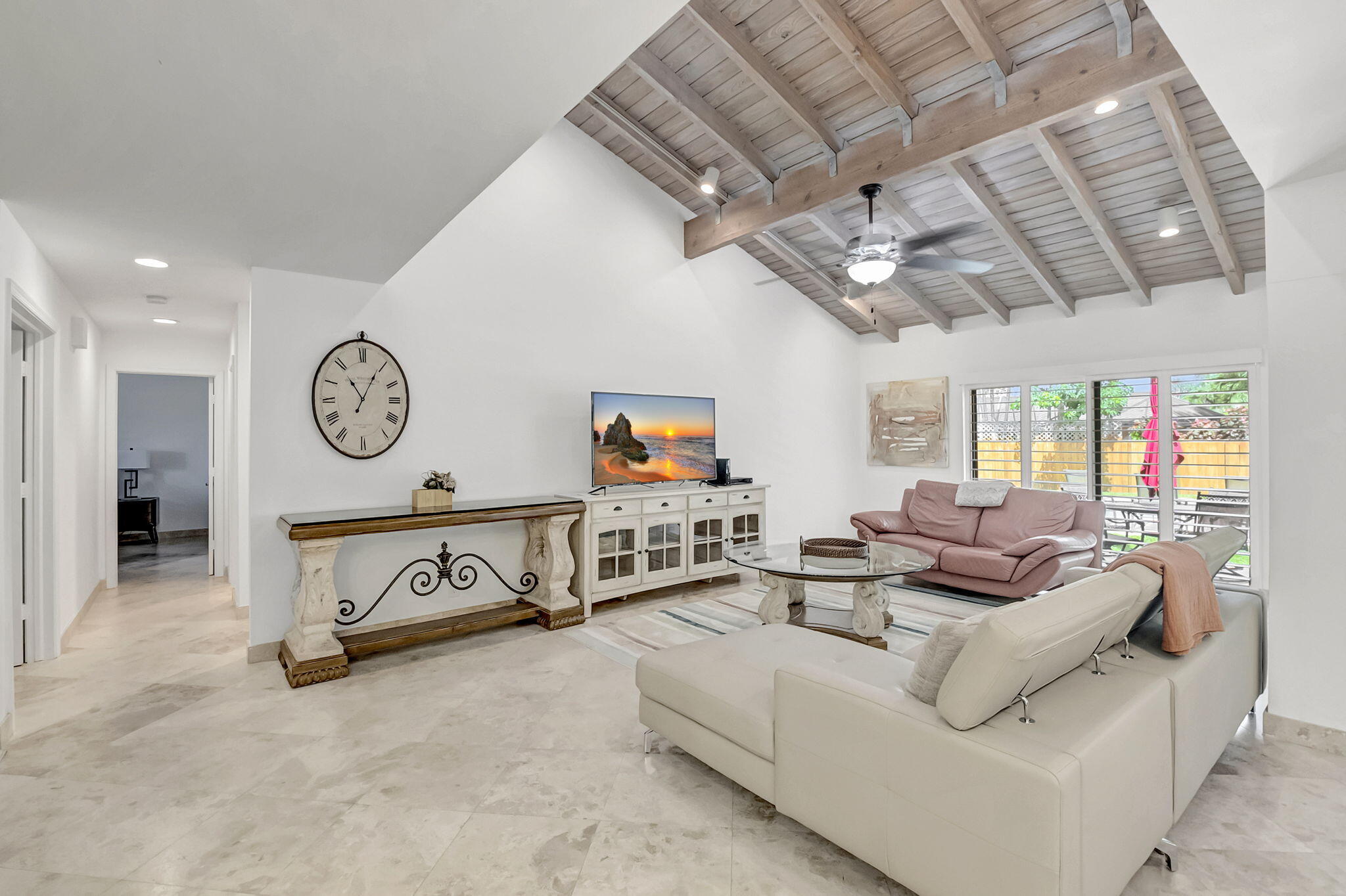 804 Foxpointe Circle Delray Beach, FL 33445 - Photo 8 of 43 a living room with furniture a clock and a ceiling fan