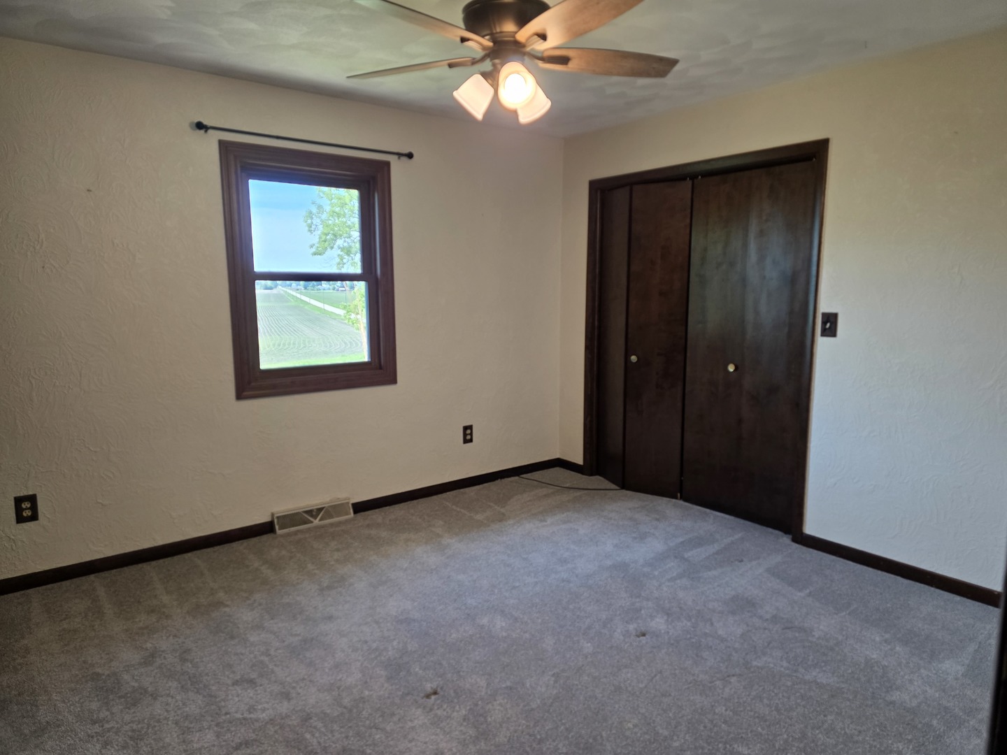 15510 Lomax Road Prophetstown, IL 61277 - Photo 10 of 24 an empty room with closet and a chandelier fan
