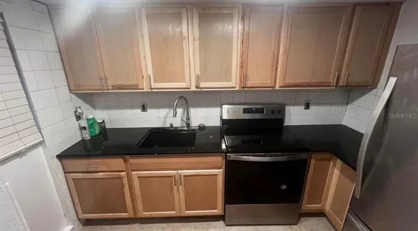 a kitchen with a sink and cabinets
