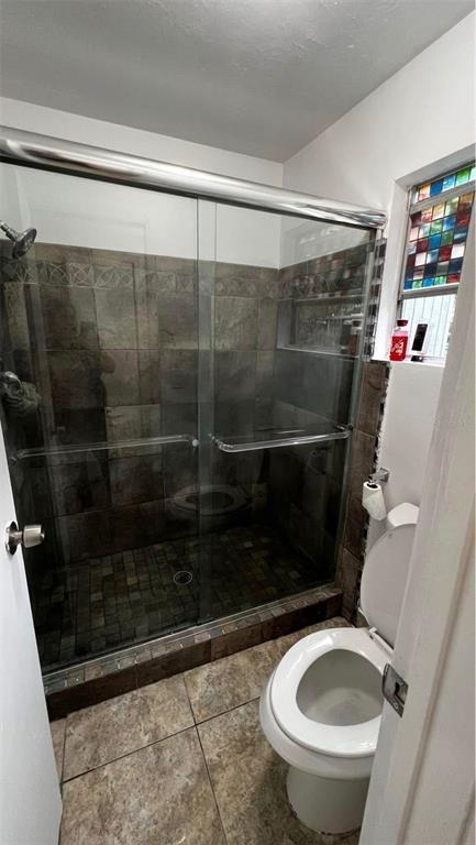 707 Southwest 75th Street, Unit 109 Gainesville, FL 32607 - Photo 6 of 13 a bathroom with a shower and a toilet