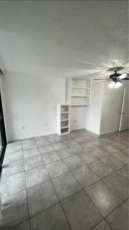 a view of a room with an empty space and window