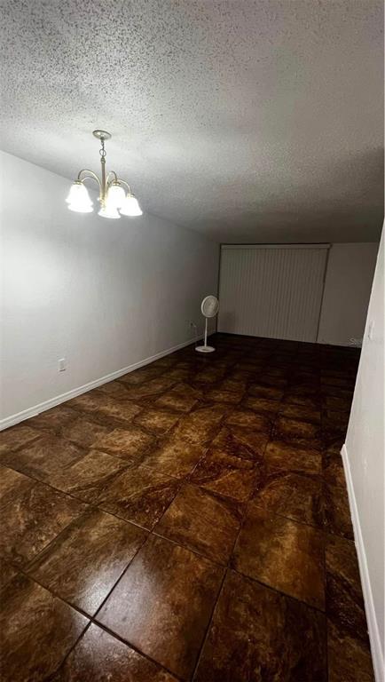 707 Southwest 75th Street, Unit 109 Gainesville, FL 32607 - Photo 8 of 13 a view of an empty room with a chandelier fan