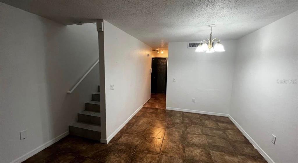 707 Southwest 75th Street, Unit 109 Gainesville, FL 32607 - Photo 10 of 13 wooden floor in an empty room with a gallery