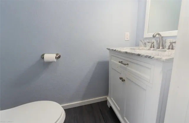 a bathroom with a sink a toilet and vanity
