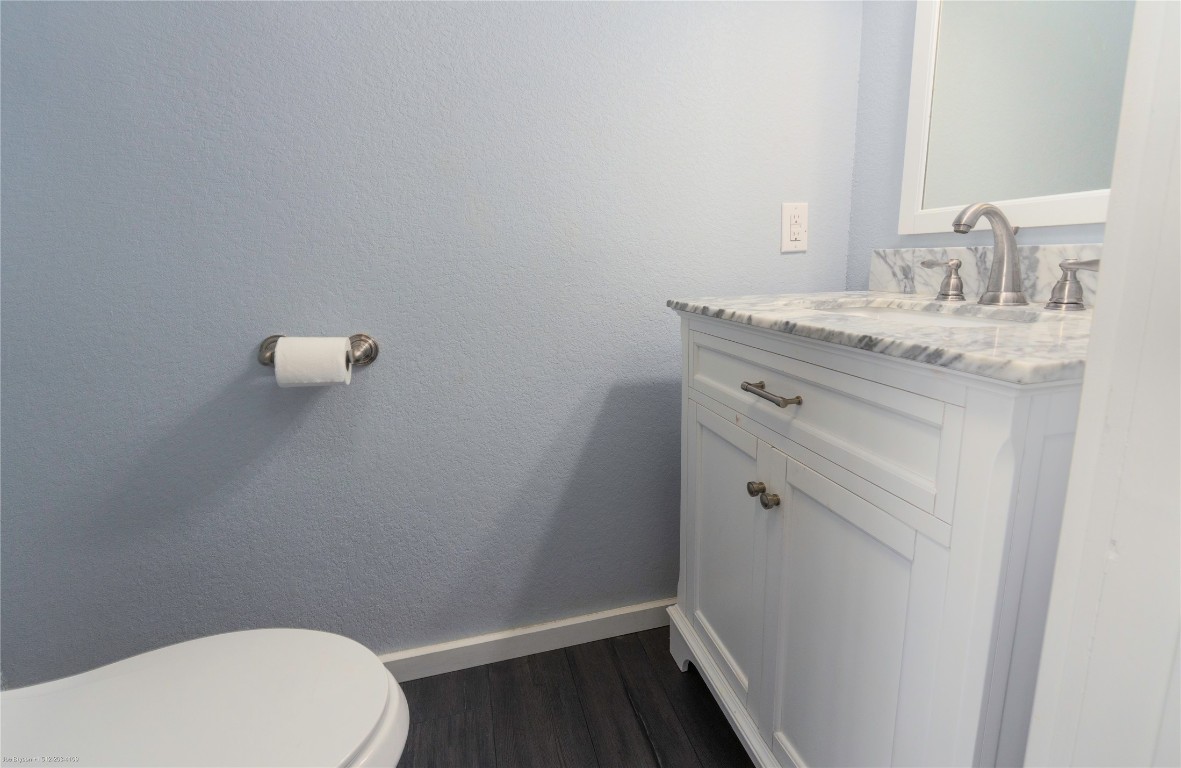 1845 River Crossing Circle, Unit C Austin, TX 78741 - Photo 13 of 28 a bathroom with a sink a toilet and vanity