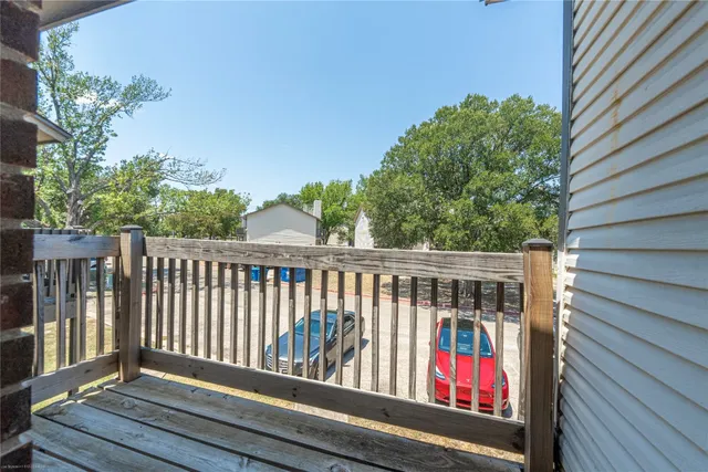 a balcony with wooden floor and outdoor space
