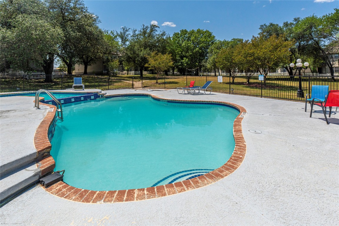 1845 River Crossing Circle, Unit C Austin, TX 78741 - Photo 23 of 28 swimming pool with an outdoor seating
