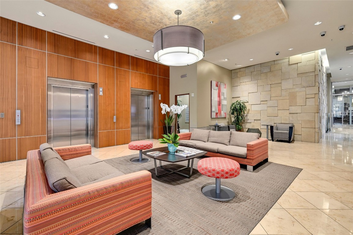 555 East 5th Street, Unit 2721 Austin, TX 78701 - Photo 22 of 33 a living room with fireplace furniture and a chandelier