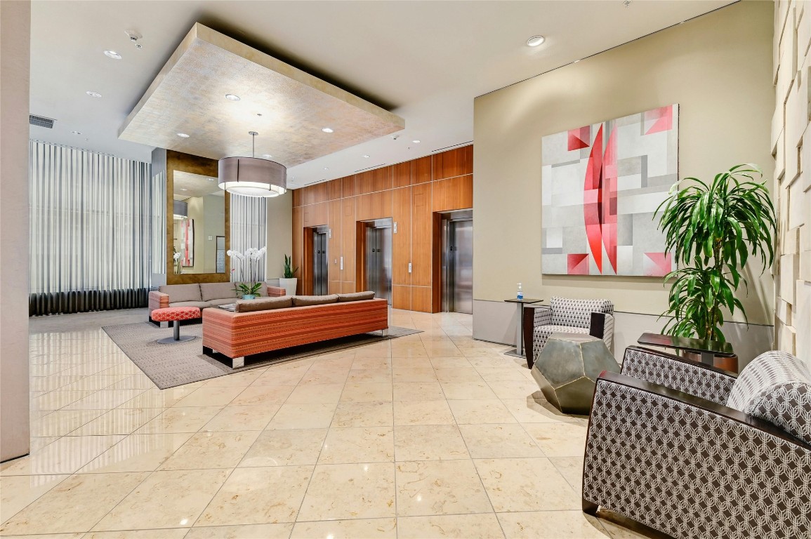 555 East 5th Street, Unit 2721 Austin, TX 78701 - Photo 25 of 33 a living room with furniture and a chandelier