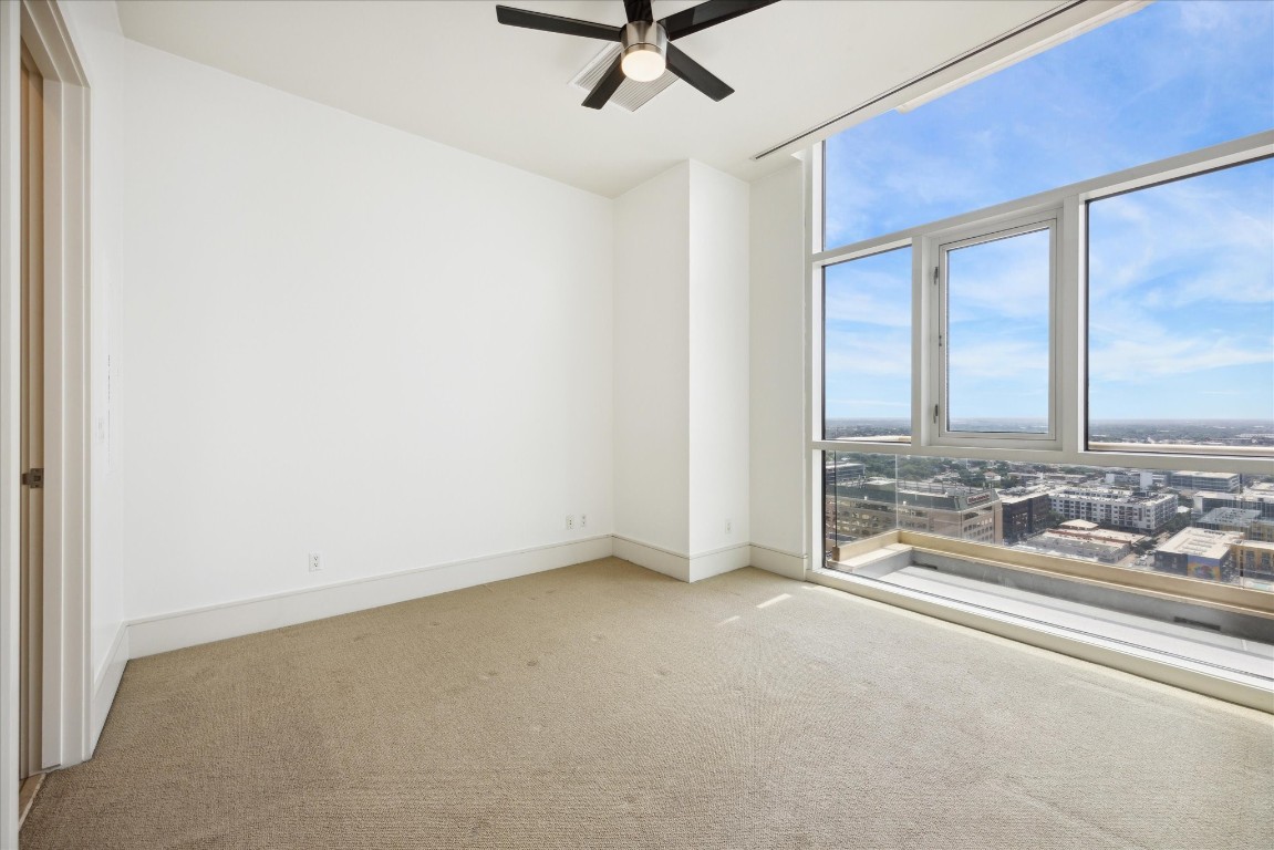 555 East 5th Street, Unit 2721 Austin, TX 78701 - Photo 31 of 33 an empty room with a large window and chandelier