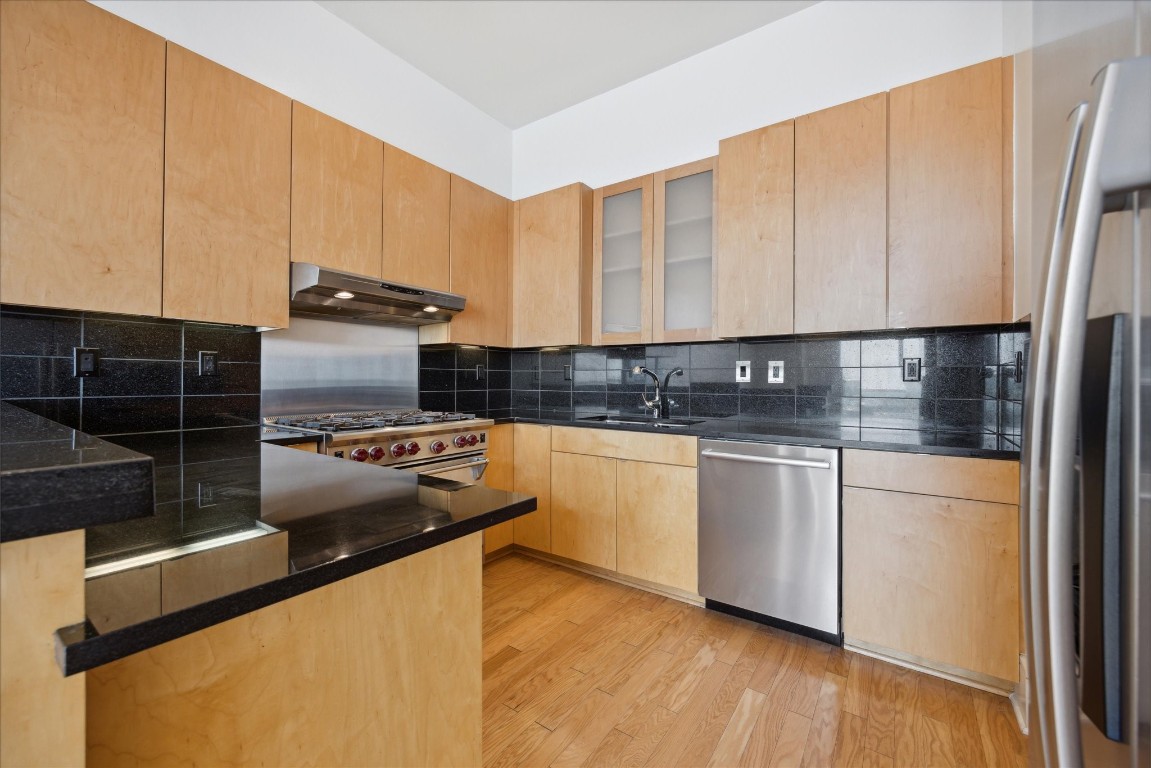 555 East 5th Street, Unit 2721 Austin, TX 78701 - Photo 5 of 33 a kitchen with stainless steel appliances granite countertop a stove a sink and a refrigerator