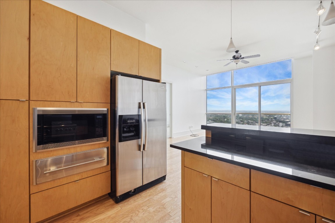 555 East 5th Street, Unit 2721 Austin, TX 78701 - Photo 6 of 33 a kitchen with stainless steel appliances granite countertop a refrigerator and a stove