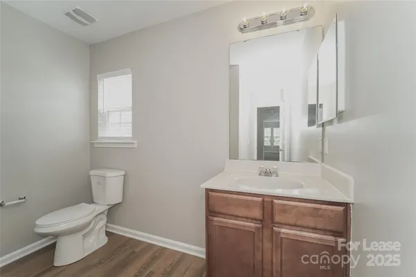 a bathroom with a sink a toilet and mirror