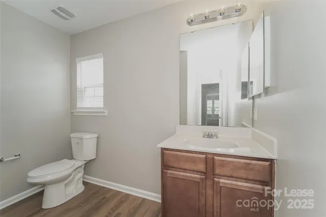 a bathroom with a sink a toilet and mirror