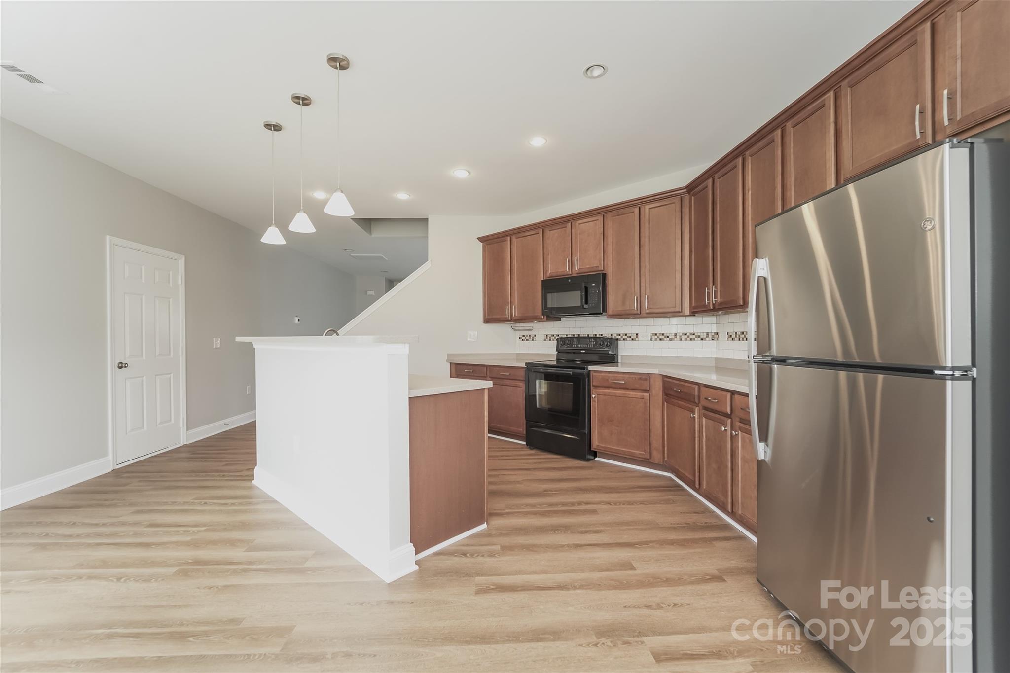 4416 Marys Point Road Monroe, NC 28110 - Photo 7 of 12 a kitchen with a refrigerator a sink and cabinets
