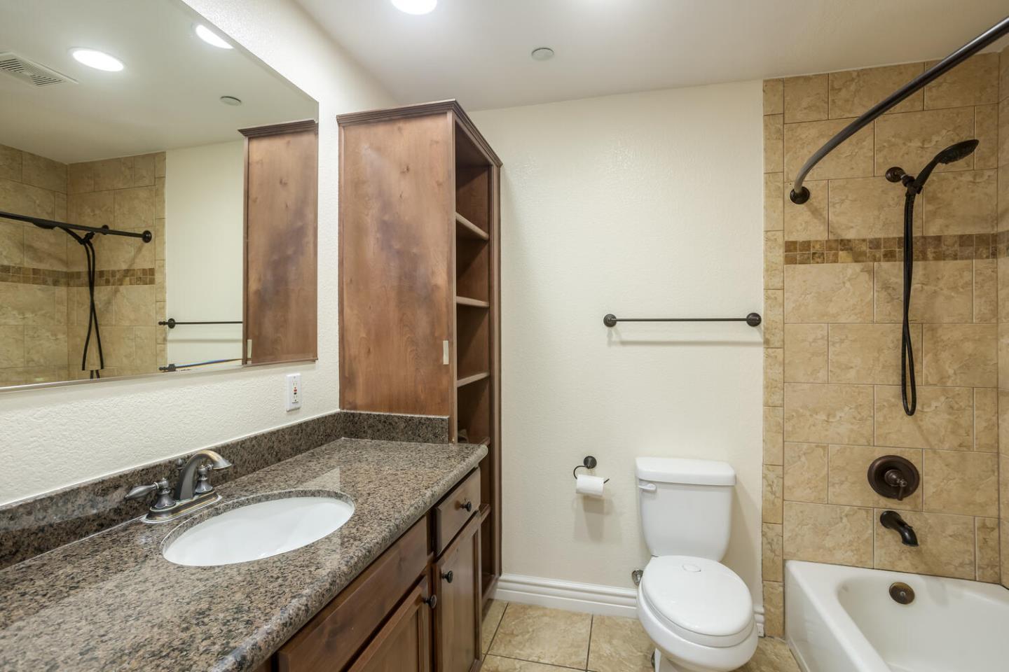 2580 Homestead Road, Unit 5101 Santa Clara, CA 95051 - Photo 16 of 33 a bathroom with a granite countertop sink toilet and shower